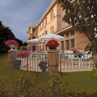 A beautiful outdoor terrace adorned with flowers, providing a serene view of the surrounding garden.