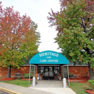Entrance to a care center with colorful trees and an awning.