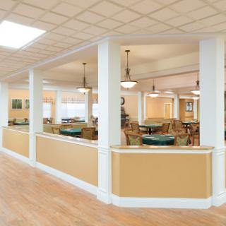 A bright and inviting dining area featuring elegant furniture and warm lighting.