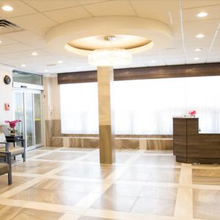 A well-lit, modern lobby with comfortable seating and a reception desk.
