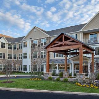 A modern residential building with an inviting entrance and well-maintained landscaping.