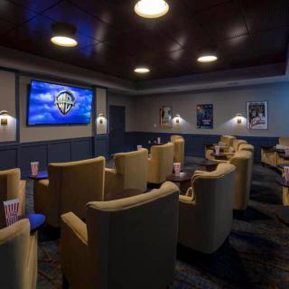 A cozy home theater setup with comfortable seating and a large screen.