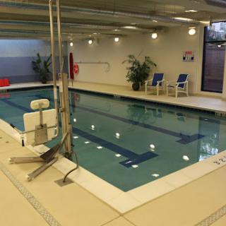 A serene indoor swimming pool equipped for relaxation and fitness.