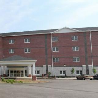 A large brick hotel building with multiple windows and an entrance canopy.