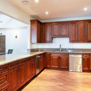 A modern kitchen with wooden cabinets and stainless steel appliances.