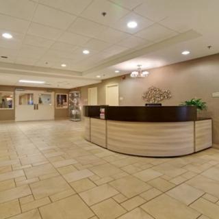 A modern reception area with a central desk and tile flooring.