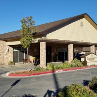 A modern commercial building with a welcoming entrance and landscaped surroundings.