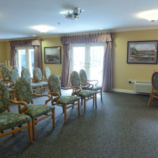 A well-lit meeting room with arranged chairs and decor.
