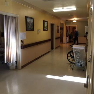 A hospital corridor with a wheelchair, showing medical facility interior.