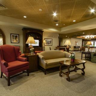 A cozy living room with comfortable seating and warm lighting.