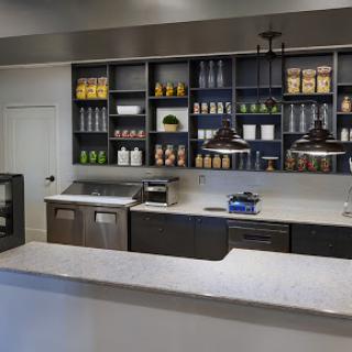 A modern kitchen featuring stylish shelves and a sleek countertop.
