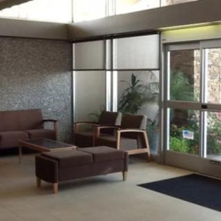 A modern lobby with comfortable seating and a large entrance.