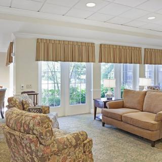 A cozy living room with comfortable seating and large windows.