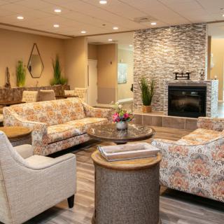 A cozy living room with comfortable seating and a modern fireplace.