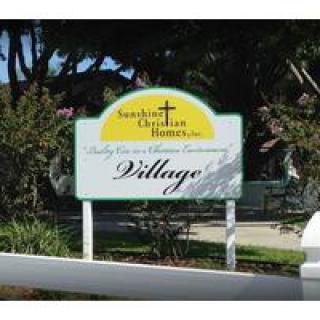 A sign for the Sunlight Christian Homes housing community.