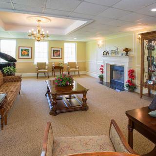 A well-decorated living room featuring elegant furniture and a cozy fireplace.