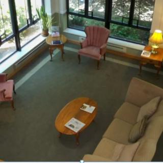 A cozy waiting room with comfortable seating and large windows.