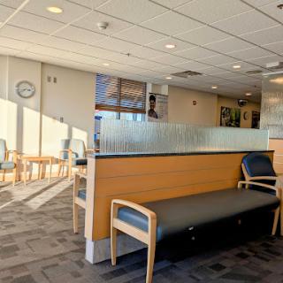 A bright and spacious waiting area in a healthcare facility, featuring comfortable seating and a calm atmosphere.