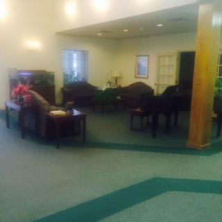 A cozy waiting room featuring several chairs and a coffee table.