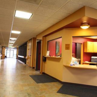 A modern office hallway with a reception desk.