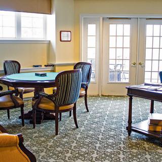 Cozy room interior with elegant furniture and patterned carpet.