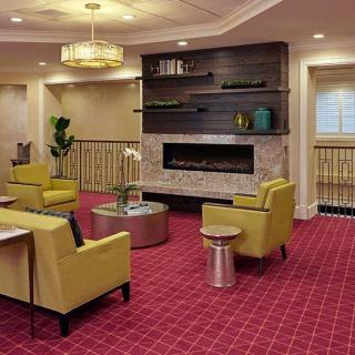 Modern lobby with a cozy seating area and fireplace.
