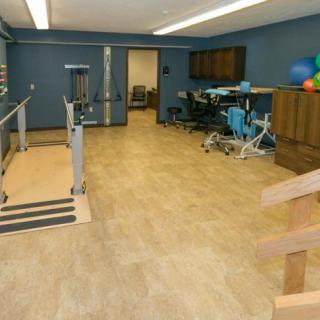 A rehabilitation room equipped with exercise and therapy equipment.