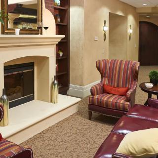 A cozy living room featuring a fireplace and traditional decor.