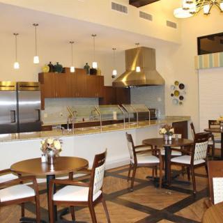 A modern kitchen and dining area with elegant seating and lighting.