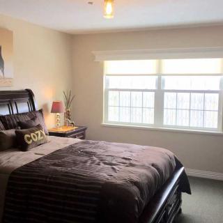 A cozy bedroom with a large window letting in natural light.