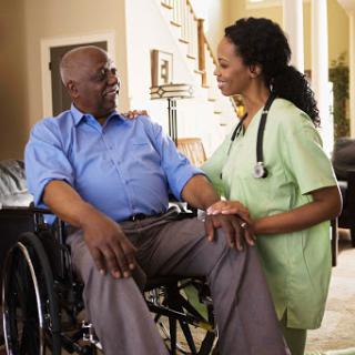 A compassionate nurse engages with a patient in a wheelchair, fostering a supportive healthcare environment.