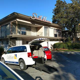 A vehicle parked in front of a hotel, ready for pick-up.