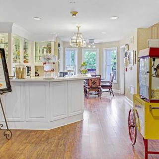 A bright and welcoming kitchen interior with a popcorn machine and dining area.