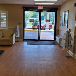 A welcoming lobby featuring seating and a view of the entrance doors.