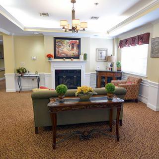 A cozy living room with a sofa, fireplace, and tasteful decor.