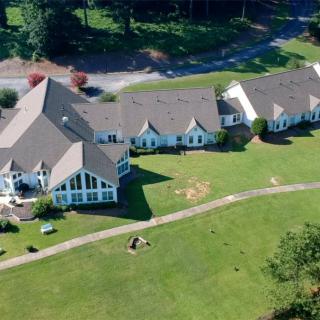 An aerial view of a large building complex surrounded by lush greenery.