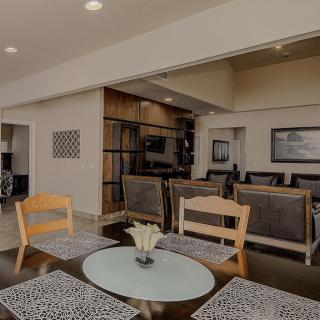 A modern dining room featuring a large table with mixed chairs and stylish decor.