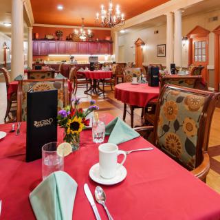A well-decorated restaurant dining area with neatly set tables and elegant furnishings.