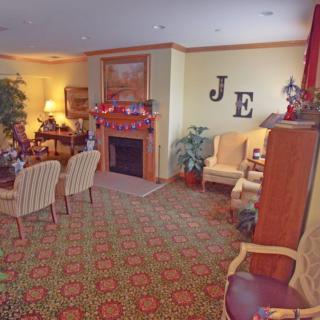 A cozy living room with a fireplace and comfortable seating area.