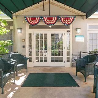 A welcoming entrance with seating, adorned with patriotic bunting.