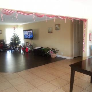 A cozy living room decorated for the holidays with a Christmas tree and presents.