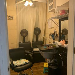 A cozy hair salon with styling chairs and hair dryers.