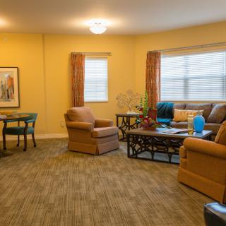 A cozy living room with comfortable seating and large windows.