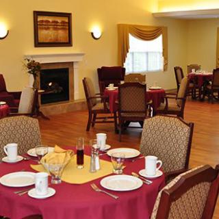A cozy dining room with neatly set tables and a warm ambiance.