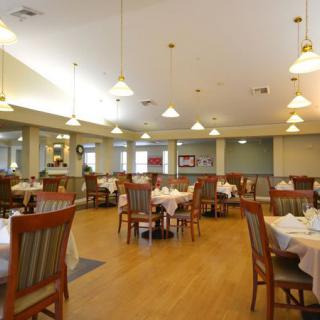 An elegant and spacious restaurant dining area with neatly arranged tables and chairs.