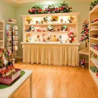 Beautifully arranged gift shop interior with decorative items and flowers on display.