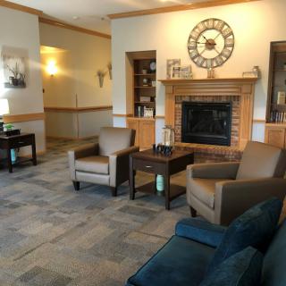 A cozy living room with a fireplace and comfortable seating.