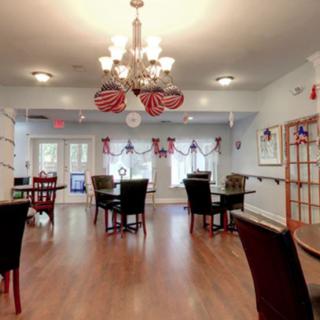 A cozy dining room with elegant chandeliers and festive decorations.