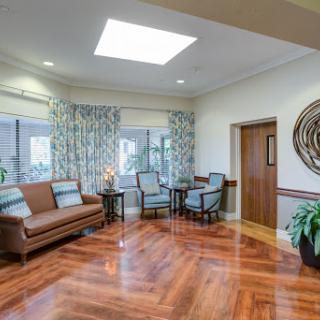 A cozy living room featuring a mix of natural light, comfortable seating, and elegant decor.