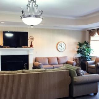 A cozy living room with a fireplace, television, and comfortable seating.